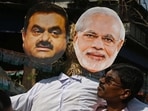 A Congress worker carries an effigy of Prime Minister Narendra Modi and Indian tycoon Gautam Adani during a rally organised to protest against government's financial policies.