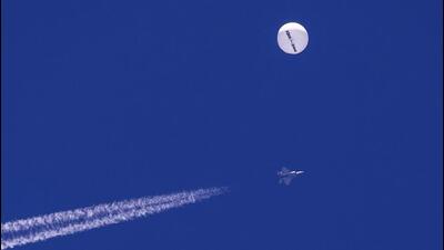 A large balloon drifts above the Atlantic Ocean, just off the coast of South Carolina, with a fighter jet and its contrail seen below it, on February 4. (AP) A large balloon drifts above the Atlantic Ocean, just off the coast of South Carolina, with a fighter jet and its contrail seen below it, on February 4. (AP)