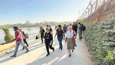 Nearly 200 residents, dressed in black, walked together at Sankey Tank on Sunday morning in protest against the road widening and flyover project. (HT Photo)