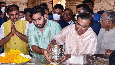Industrialist Mukesh Ambani and his son Akash Ambani performs rituals at Somnath Mahadev temple on Mahashivratri festival, in Prabhas Patan, Saturday. (PTI)