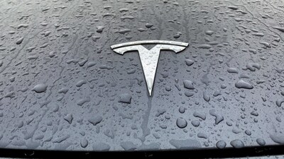 A view shows the Tesla logo on the hood of a car. (REUTERS)