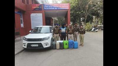 The accused, along with the car and the cans used in the crime, in the custody of Chandigarh Police. (HT Photo) The accused, along with the car and the cans used in the crime, in the custody of Chandigarh Police. (HT Photo)