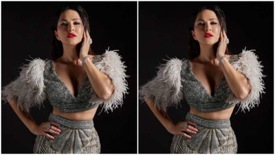 Sunny decked up in cropped silver sequined blouse featuring a plunging neckline, and white feather details at the sleeves. She teamed it with a silver sequined bodycon skirt featuring wave patterns at the ankles and an elaborate train. (Instagram/@sunnyleone) Sunny decked up in cropped silver sequined blouse featuring a plunging neckline, and white feather details at the sleeves. She teamed it with a silver sequined bodycon skirt featuring wave patterns at the ankles and an elaborate train. (Instagram/@sunnyleone)