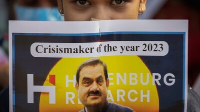 An activist of the youth wing of Congress party holds a placard featuring Gautam Adani, chairman of Adani Group. (Reuters / File)
