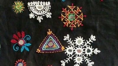 Mirror work: Mirror work, also known as shisha embroidery, involves stitching small mirrors onto fabrics to create beautiful designs. It is commonly used on traditional Gujarati clothing like chaniya cholis and ghagras. (Pinterest) Mirror work: Mirror work, also known as shisha embroidery, involves stitching small mirrors onto fabrics to create beautiful designs. It is commonly used on traditional Gujarati clothing like chaniya cholis and ghagras. (Pinterest)