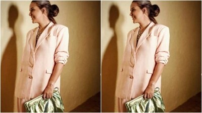 Neha added the necessary pop of colours to her look in a metallic golden green statement purse in one hand. “Blushing,” she captioned her pictures. (Instagram/@nehadhupia) Neha added the necessary pop of colours to her look in a metallic golden green statement purse in one hand. “Blushing,” she captioned her pictures. (Instagram/@nehadhupia)