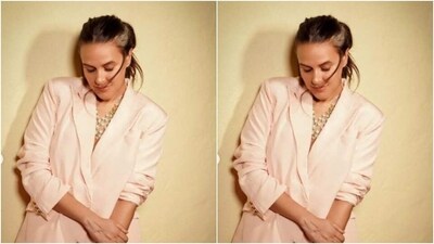 Neha decked up in a pastel pink blazer with lapel collars, a plunging neckline, and full sleeves rolled up. She teamed it with a pair of matching satin formal trousers with wide legs. (Instagram/@nehadhupia) Neha decked up in a pastel pink blazer with lapel collars, a plunging neckline, and full sleeves rolled up. She teamed it with a pair of matching satin formal trousers with wide legs. (Instagram/@nehadhupia)