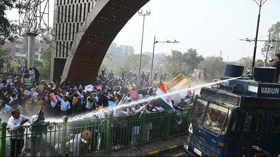 Police teams using water cannons to disperse the crowd of protesting government employees near the Panchkula-Chandigarh border. (Sant Arora/HT)