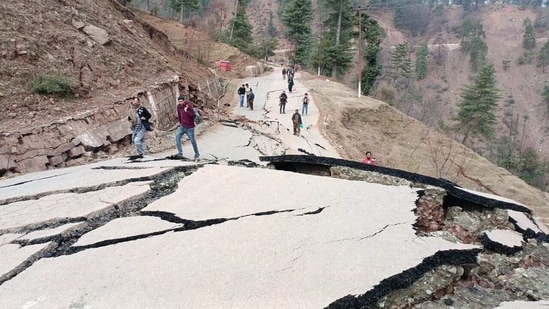 Cracks on the road caused by a landslide in Duksar Dal village in Gool sub-division in Ramban district.(HT Photo)