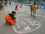 People paint the road on the eve of International Mother Language Day, in Kolkata on Monday. (ANI Photo) People paint the road on the eve of International Mother Language Day, in Kolkata on Monday. (ANI Photo)
