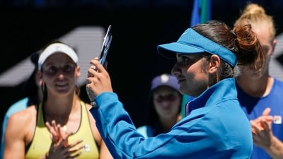 Sania Mirza holds her trophy following the mixed doubles final loss to Brazil's Luisa Stefani and Rafael Matos at the Australian Open (AP)