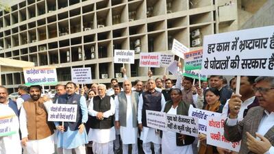 Leader of opposition in the Haryana assembly and former chief minister Bhupinder Singh Hooda (centre) leading Congress MLAs in the protest outside the state assembly in Chandigarh on Tuesday. (Ravi Kumar/HT)