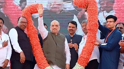 Union Home Minister Amit Shah with Maharashtra Deputy Chief Minister Devendra Fadnavis being garlanded during the Vijay Sankalp Mela, in Kolhapur on Sunday. (ANI)