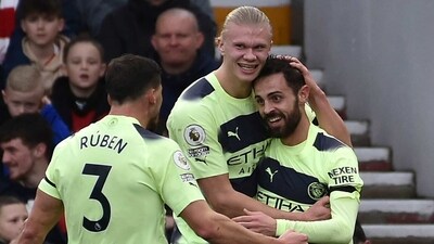 Manchester City's Bernardo Silva celebrates Manchester City's Ruben Dias and Manchester City's Erling Haaland after scoring his side's opening goal (AP)