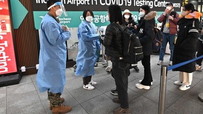 Covid In South Korea: Health workers guide travellers arriving from China. (AFP) Covid In South Korea: Health workers guide travellers arriving from China. (AFP)