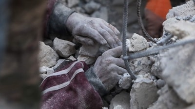 Turkey Earthquake: A rescue worker digs to reach a boy under the rubble. (AFP) Turkey Earthquake: A rescue worker digs to reach a boy under the rubble. (AFP)
