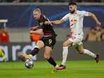Manchester City's Norwegian striker Erling Haaland (L) gets a shot away past Leipzig's Croatian defender Josko Gvardiol during the UEFA Champions League round of 16, first-leg football match between RB Leipzig and Manchester City in Leipzig, eastern Germany on February 22, 2023. (Photo by Odd ANDERSEN / AFP)