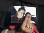 Renu, eldest sister of missing British girl Shamima Begum, holds a picture of her sister Shamima, while being interviewed by the media in central London.
