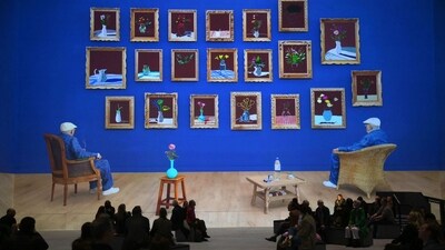 Visitors seen at the exhibit with Hockney's ‘Looking at the flowers’ in the background, in London, on February 22. The exhibit is divided into six themed chapters delving into his creative processes and accompanied by a musical score by American composer Nico Muhly. (Daniel Leal / AFP) Visitors seen at the exhibit with Hockney's ‘Looking at the flowers’ in the background, in London, on February 22. The exhibit is divided into six themed chapters delving into his creative processes and accompanied by a musical score by American composer Nico Muhly. (Daniel Leal / AFP)