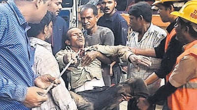 A construction worker being taken out of the soil cave-in at a construction site in Thane on Thursday. (PRAFUL GANGURDE / HT PHOTO)