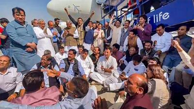 Congress leaders protesting on the tarmac. (PTI) Congress leaders protesting on the tarmac. (PTI)