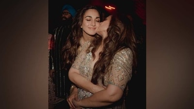 Kiara gets a peck on the cheeks from her mother during the Sangeet ceremony. She had donned a heavily-embellished gold lehenga and bralette set for the special occasion. The actor's mother complemented her in a beige sequinned ensemble. (Instagram) Kiara gets a peck on the cheeks from her mother during the Sangeet ceremony. She had donned a heavily-embellished gold lehenga and bralette set for the special occasion. The actor's mother complemented her in a beige sequinned ensemble. (Instagram)