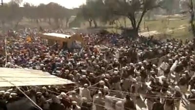 Thousands of protesters were seen trying to break through a police barricade near the Ajnala police station. (ANI)