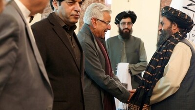 Mullah Abdul Ghani Baradar, the Taliban-appointed deputy prime minister for economic affairs, right, shakes hands with Pakistan's defense minister, Khawaja Mohammad Asif, during a meeting in Kabul on Wednesday, (AP) Mullah Abdul Ghani Baradar, the Taliban-appointed deputy prime minister for economic affairs, right, shakes hands with Pakistan's defense minister, Khawaja Mohammad Asif, during a meeting in Kabul on Wednesday, (AP)