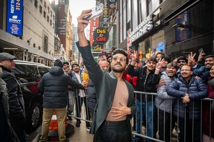 Ram Charan clicks a selfie with fans outside the venue. Ram Charan clicks a selfie with fans outside the venue.