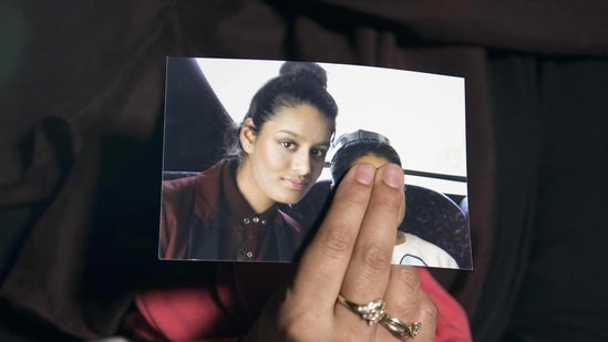 Renu, eldest sister of missing British girl Shamima Begum, holds a picture of her sister Shamima, while being interviewed by the media in central London. (AFP file)