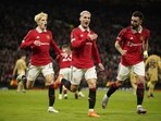 Manchester United's Antony, center, celebrates after scoring his side's second goal during the Europa League playoff second leg soccer match between Manchester United and Barcelona at Old Trafford stadium in Manchester, England, Thursday, Feb. 23, 2023. (AP Photo/Dave Thompson)