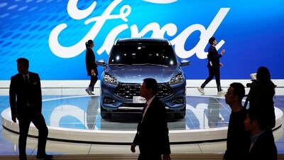 People walk by a Ford Escape SUV displayed during the media day for the Shanghai auto show in Shanghai. (REUTERS/ Representative Image)