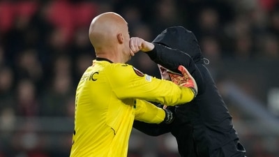 A PSV supporter punches Sevilla's goalkeeper Marko Dmitrovic in the face during the Europa League playoff second leg soccer match between PSV and Sevilla at the Philips stadium in Eindhoven, Netherlands, Thursday, Feb. 23, 2023. Sevilla won 3-2 on aggregate. (AP Photo/Peter Dejong) (AP) A PSV supporter punches Sevilla's goalkeeper Marko Dmitrovic in the face during the Europa League playoff second leg soccer match between PSV and Sevilla at the Philips stadium in Eindhoven, Netherlands, Thursday, Feb. 23, 2023. Sevilla won 3-2 on aggregate. (AP Photo/Peter Dejong) (AP)