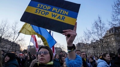 A Ukrainian supporter holds a placard to mark the one-year anniversary of the full-scale Russian invasion of Ukraine during a gathering at Place de la Republique in Paris, (AP) A Ukrainian supporter holds a placard to mark the one-year anniversary of the full-scale Russian invasion of Ukraine during a gathering at Place de la Republique in Paris, (AP)
