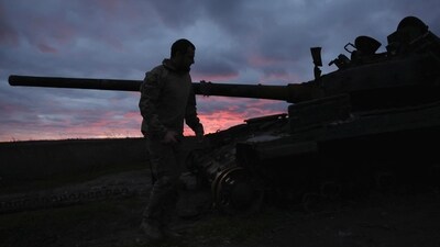 Russia-Ukraine War: A Ukrainian serviceman walks near a destroyed tank at sunset, as Russia's invasion of Ukraine continues, near Izium, Ukraine. (Reuters)