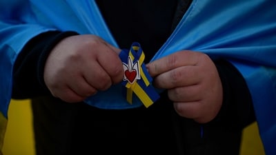 A person wrapped with Ukraine flag takes part in a protest marking one year since Russia's invasion of Ukraine, in Pamplona, northern Spain. (AP) A person wrapped with Ukraine flag takes part in a protest marking one year since Russia's invasion of Ukraine, in Pamplona, northern Spain. (AP)