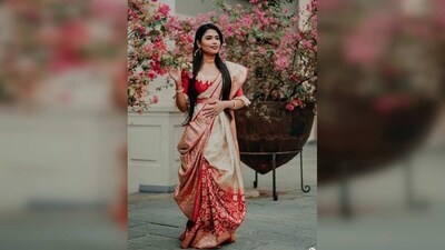 Bengali style: This style is popular in West Bengal and is known for its elegant look. The saree is draped in a way that the pallu is draped twice around the body and is then brought back over the left shoulder. (Pinterest) Bengali style: This style is popular in West Bengal and is known for its elegant look. The saree is draped in a way that the pallu is draped twice around the body and is then brought back over the left shoulder. (Pinterest)
