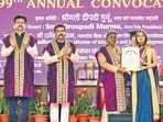 Delhi University vice-chancellor Yogesh Singh, Union education minister Dharmendra Pradhan applaud as President Droupadi Murmu confers a degree on a student at the 99th convocation ceremony on Saturday. (Raj K Raj/HT PHOTO) Delhi University vice-chancellor Yogesh Singh, Union education minister Dharmendra Pradhan applaud as President Droupadi Murmu confers a degree on a student at the 99th convocation ceremony on Saturday. (Raj K Raj/HT PHOTO)