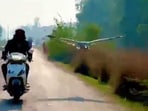 In the video, a crane can be seen flying along a man riding his two-wheeler.