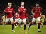 Manchester United's Antony, center, celebrates after scoring his side's second goal during the Europa League playoff second leg soccer match between Manchester United and Barcelona at Old Trafford stadium in Manchester, England, Thursday, Feb. 23, 2023. (AP Photo/Dave Thompson)