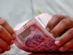 A man counts Indian currency notes inside a shop in Mumbai.