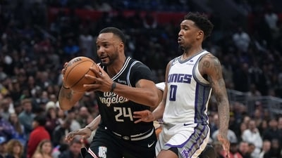 LA Clippers forward Norman Powell (24) is defended by Sacramento Kings guard Malik Monk (0) in the second half at Crypto.com Arena. The Kings defeated the Clippers 176-175 in double overtime. (USA TODAY Sports)