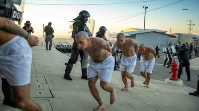 Handout picture released by the Press Secretary of the Presidency of El Salvador showing police officers keeping watch during the arrival of inmates belonging to the MS-13 and 18 gangs to the new prison "Terrorist Confinement Centre" (CECOT), in Tecoluca, 74 km southeast of San Salvador, on February 24, 2023. (AFP) Handout picture released by the Press Secretary of the Presidency of El Salvador showing police officers keeping watch during the arrival of inmates belonging to the MS-13 and 18 gangs to the new prison "Terrorist Confinement Centre" (CECOT), in Tecoluca, 74 km southeast of San Salvador, on February 24, 2023. (AFP)