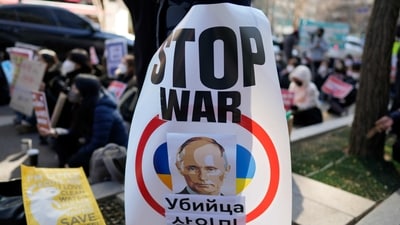 A protester holds a banner showing picture of Russian President Vladimir Putin during a rally to mark the one-year anniversary of Russia's invasion of Ukraine, in downtown Seoul, South Korea, Saturday. (AP) A protester holds a banner showing picture of Russian President Vladimir Putin during a rally to mark the one-year anniversary of Russia's invasion of Ukraine, in downtown Seoul, South Korea, Saturday. (AP)