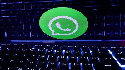A keyboard is placed in front of a displayed WhatsApp logo in this illustration. (REUTERS)