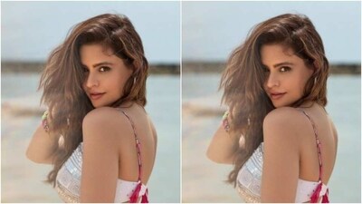 Aamna decked up in a white bra featuring silver decorations and pink slip sleeves and teamed it with a matching pencil short skirt with cut-out details at the sides of the waist featuring pink threads. (Instagram/@aamnasharifofficial) Aamna decked up in a white bra featuring silver decorations and pink slip sleeves and teamed it with a matching pencil short skirt with cut-out details at the sides of the waist featuring pink threads. (Instagram/@aamnasharifofficial)