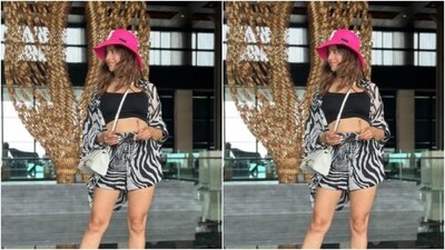 Aamna layered her look with a black top, a silk monochrome animal printed shrug and a pair of matching shorts. She added the necessary pop of colours to her look with a bright pink hat. (Instagram/@aamnasharifofficial) Aamna layered her look with a black top, a silk monochrome animal printed shrug and a pair of matching shorts. She added the necessary pop of colours to her look with a bright pink hat. (Instagram/@aamnasharifofficial)