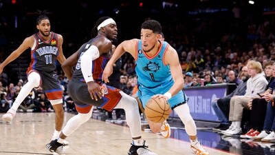 Devin Booker #1 of the Phoenix Suns drives past Luguentz Dort #5 of the Oklahoma City Thunder during the second half at Footprint Center on February 24, 2023 in Phoenix, Arizona. (Getty Images via AFP)