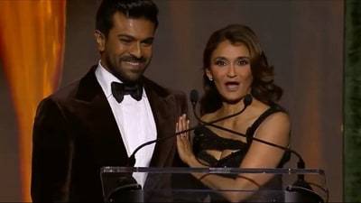 Ram Charan with Anjali Bhimani on stage. Ram Charan with Anjali Bhimani on stage.