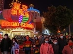 Visitors walk past the Casino Lisboa operated by SJM Holdings during Lunar New Year in Macau, China. Macau ends outdoor mask wearing as Covid-19 situation stabilises 